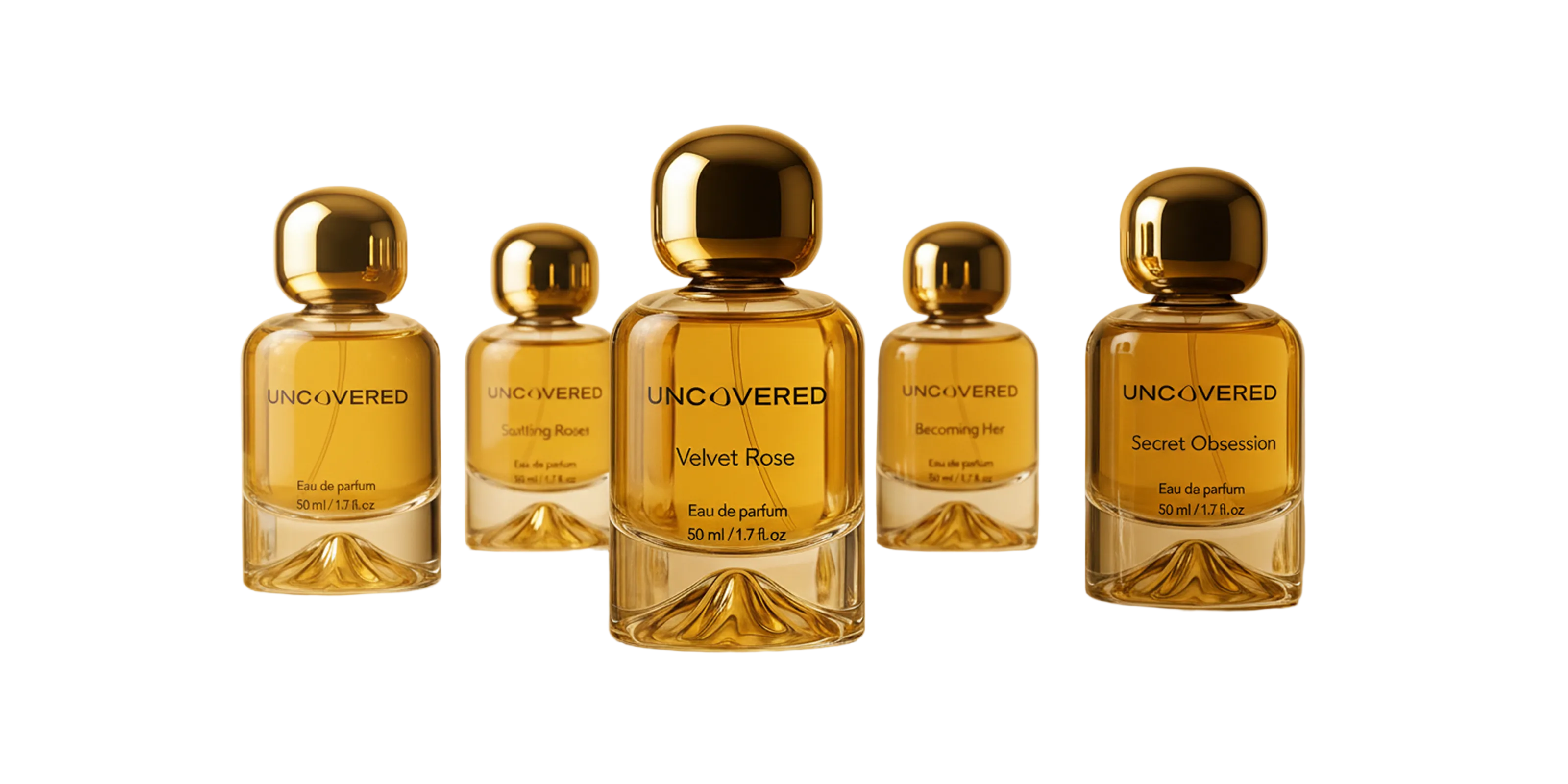 Set of five gold perfume bottles with 'UNCOVERED' branding on a reflective surface with a blurred background.