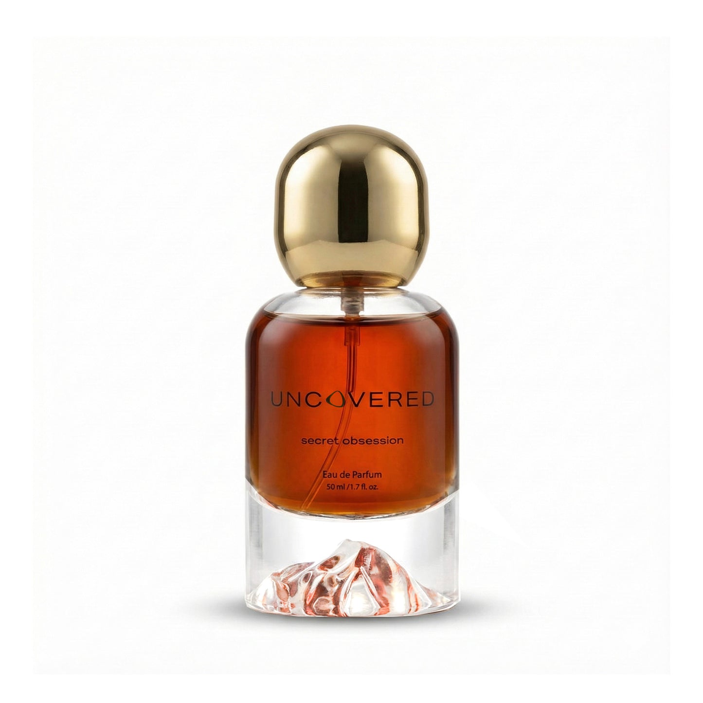 Perfume bottle labeled 'Uncovered' with a gold cap on a white background