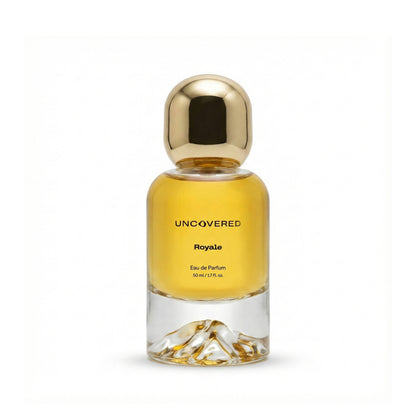 Perfume bottle labeled 'Uncovered Royale' with a gold cap on a white background